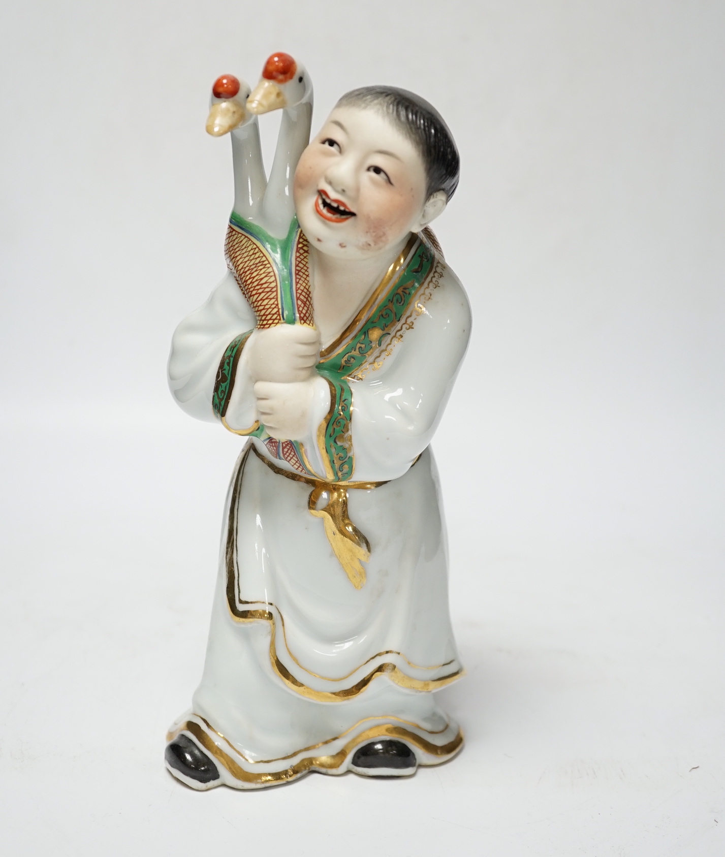 A Chinese enamelled porcelain figure of a man with two geese, 25cm high